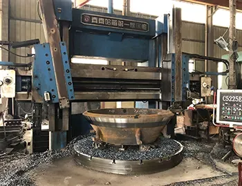 Vertical lathe turning a cone liner